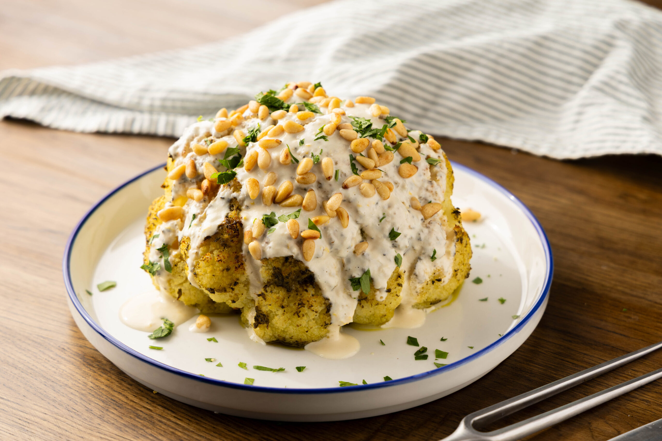 Whole Roasted Cauliflower with Maple Tahini & Pesto - Community Natural Foods